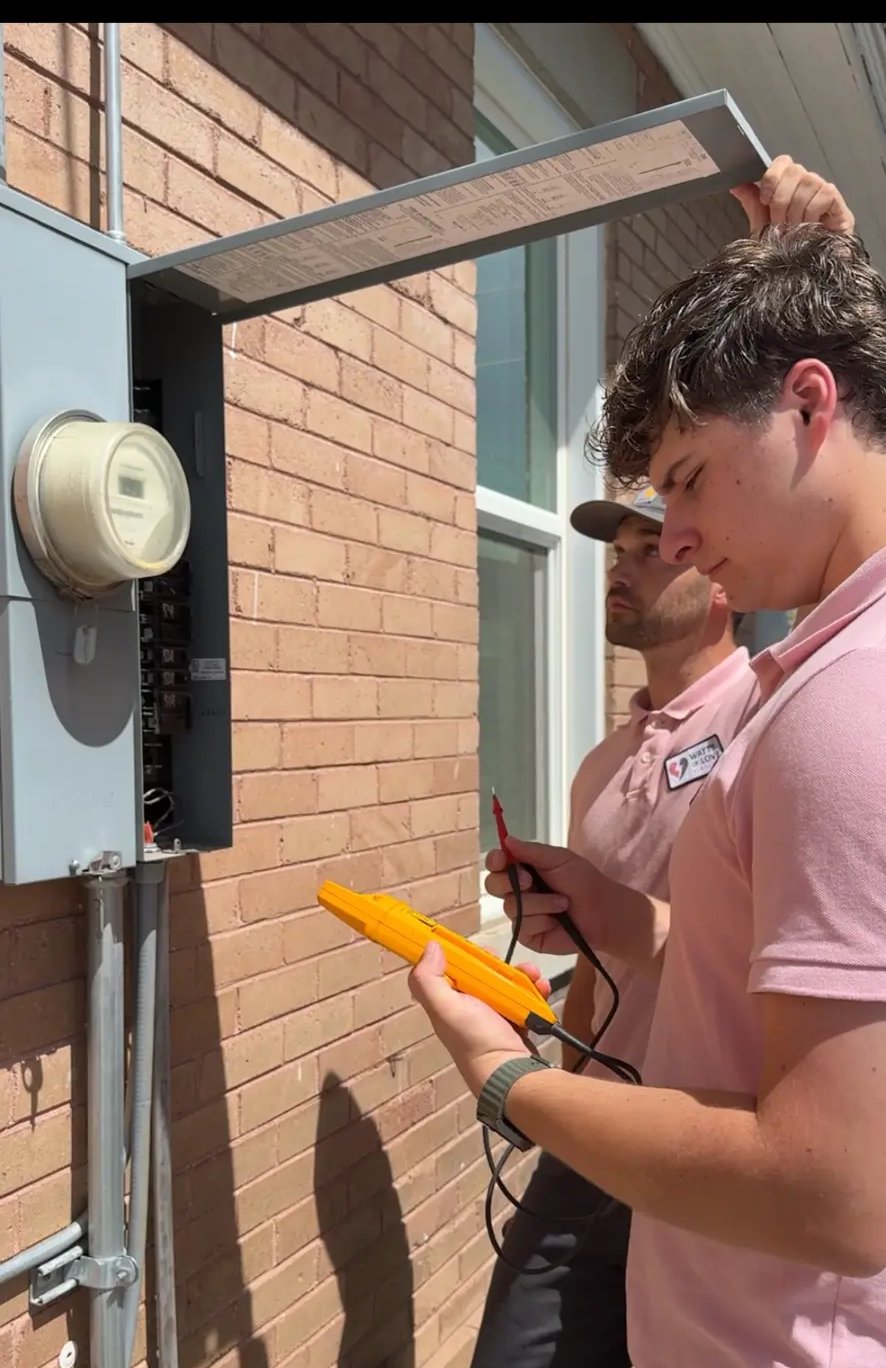 Watts of Love Electric technicians testing an outdoor electrical panel